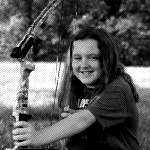 Ava standing between her grandparents, all facing away from the camera in matching red shirts. The backs of the shirts read "AVA'S GRANDMA," "BELL", and "AVA'S GRANDPA."